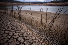 The dry cracked earth is visible near the Sau reservoir, north of Barcelona, Spain, Tuesday, April 18, 2023.