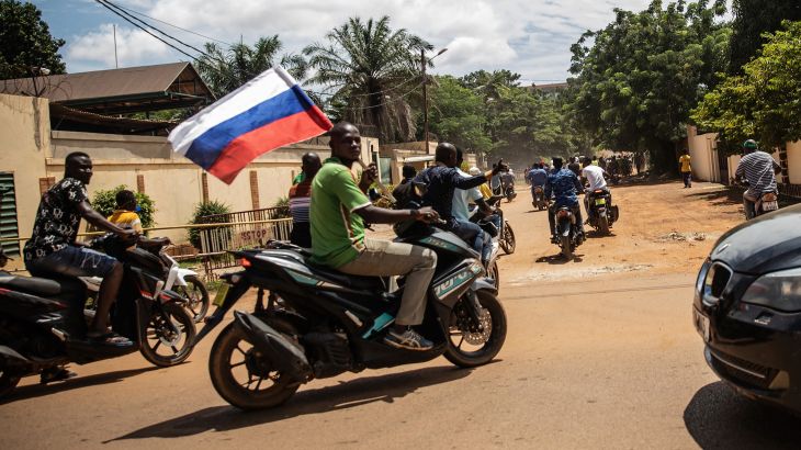 Supporters of Capt. Ibrahim Traore parade wave a Russian flag in the streets of Ouagadougou, Burkina Faso, Oct. 2, 2022.