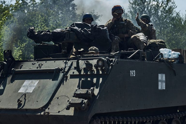 Ukrainian soldiers on an armoured vehicle in the front line in the Zaporizhzhia region
