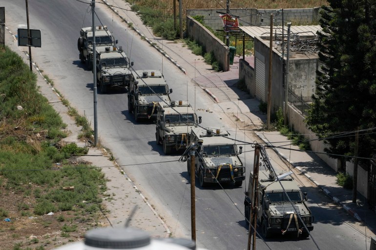 A convoy of army vehicles is seen during an Israeli military raid on the Jenin refugee camp