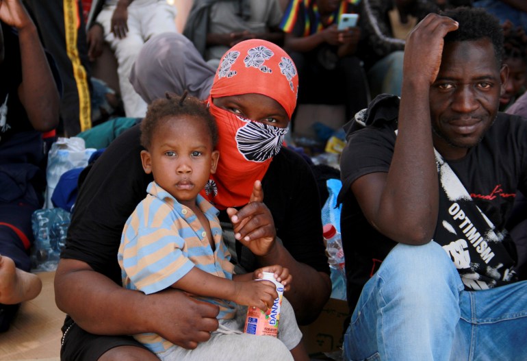 Migrants sit during a gathering in Sfax, Tunisia's eastern coast, Friday, July 7, 2023.