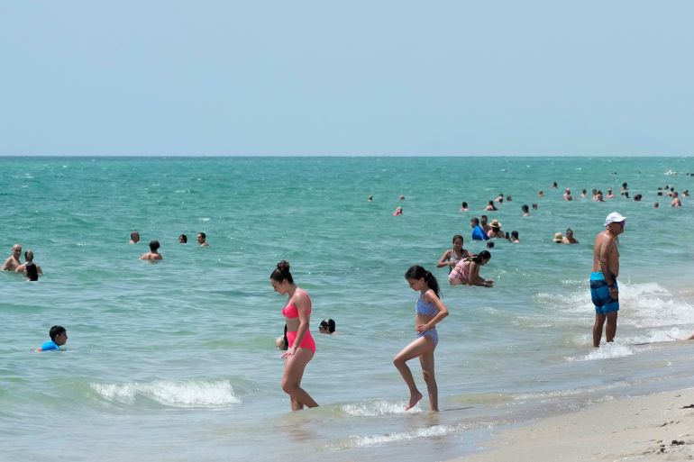 People swim in the ocean in Florida, US