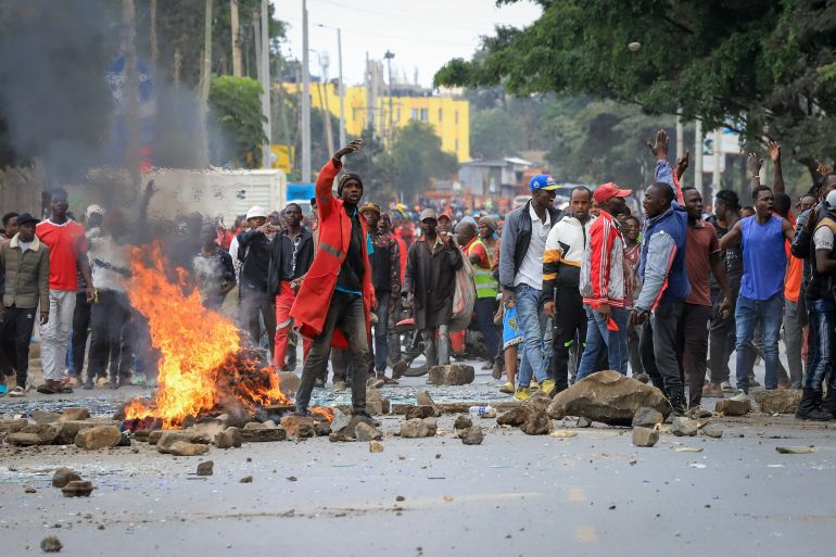 Protesters stand by a burning barricade on a street in the Mathare neighborhood of Nairobi, Kenya Wednesday, July 12, 2023