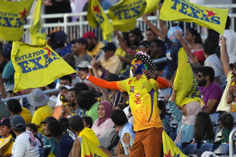 A fan in the stands cheers during a Major League Cricket match between the Los Angeles Knight Riders and the Texas Super Kings in Grand Prairie, Texas