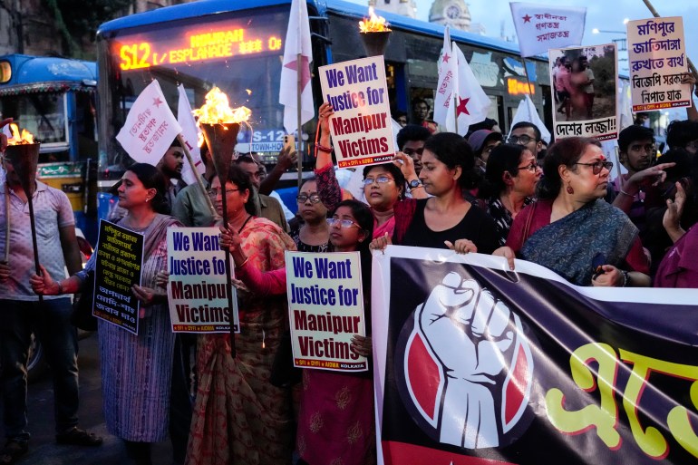 People participate in a protest against ethnic violence in Kolkata