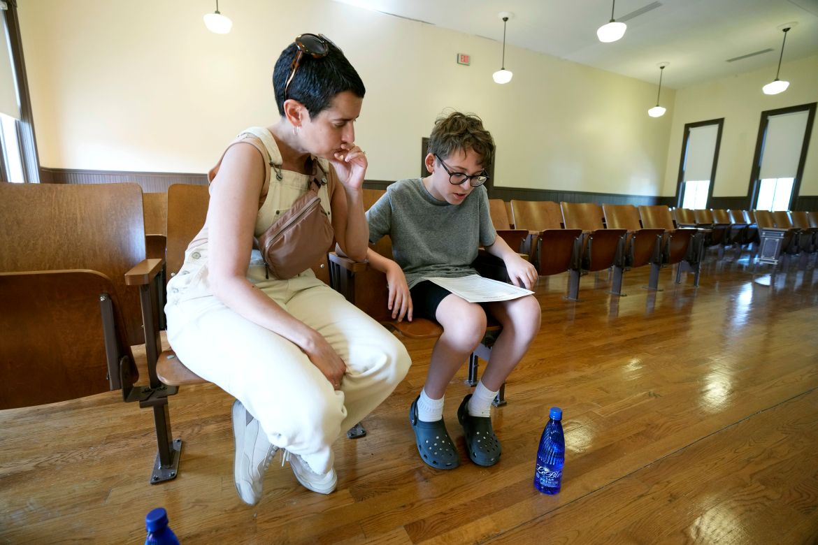 Zev Berry, 13, right, reads to his mother Ilana Berry, left, a copy of a community apology
