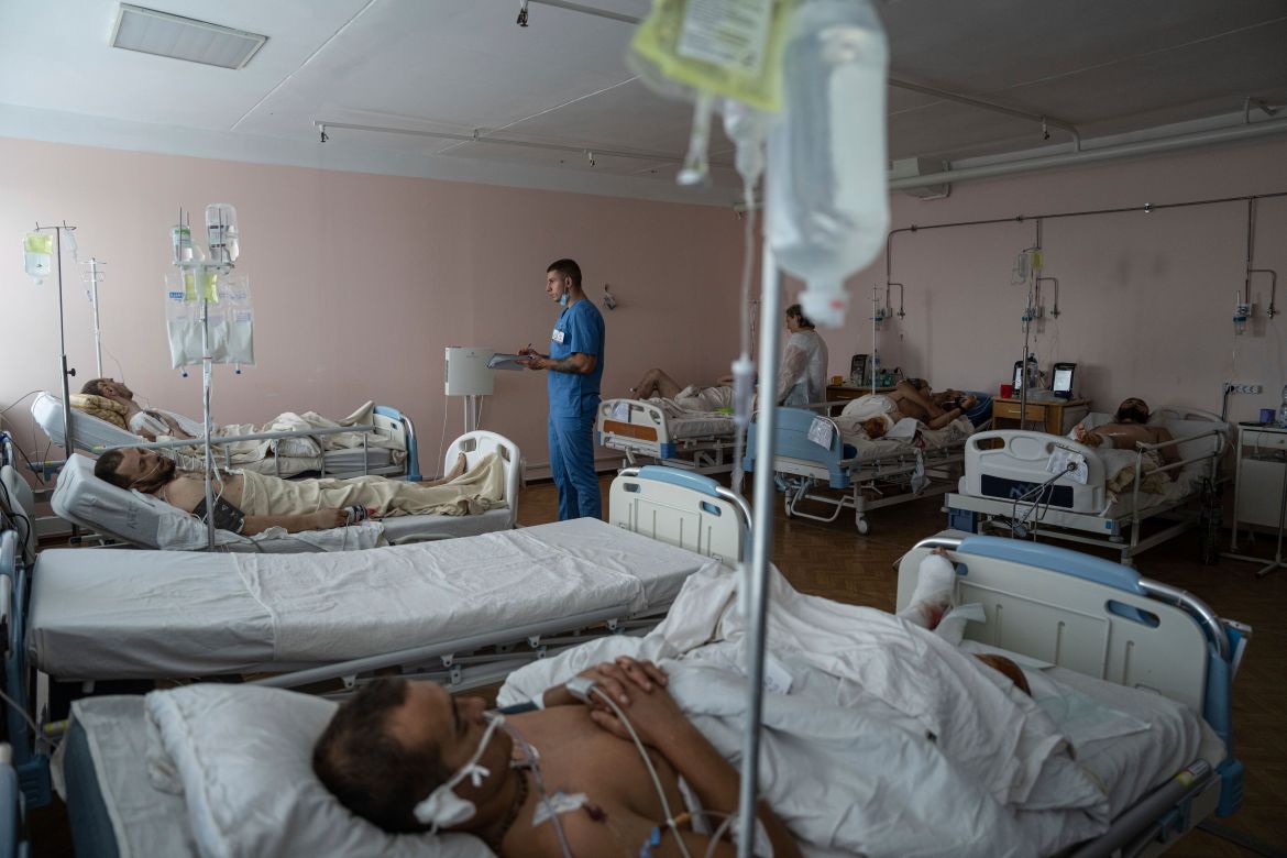A doctor writes notes inside the ICU of Mechnikov Hospital