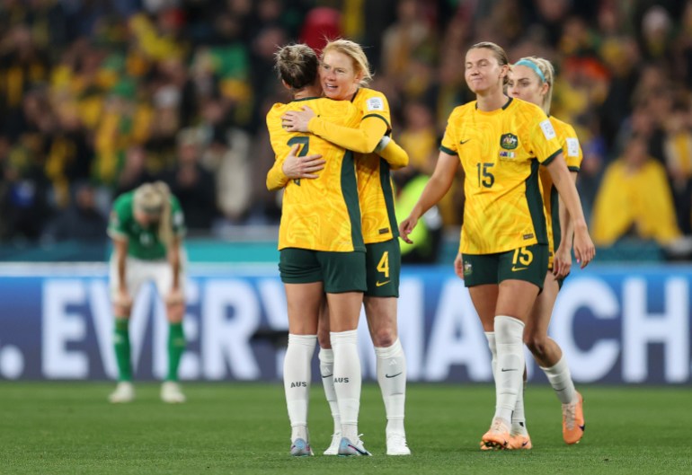 Steph Catley, left, and Australia players celebrate the team's 1-0 victory