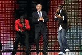 Former US diplomat Colin Powell dancing with singer Olu Maintain (red shirt) and an unnamed dancer at Africa Rising Festival, Royal Albert Hall, London, Britain, on October 14, 2008 [Brian Rasic/Getty Images]