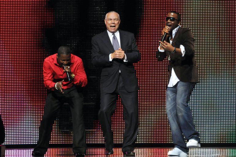 Former US diplomat Colin Powell dancing with singer Olu Maintain (red shirt) and an unnamed dancer at Africa Rising Festival, Royal Albert Hall, London, Britain - 14 Oct 2008 [Brian Rasic/Getty Images]