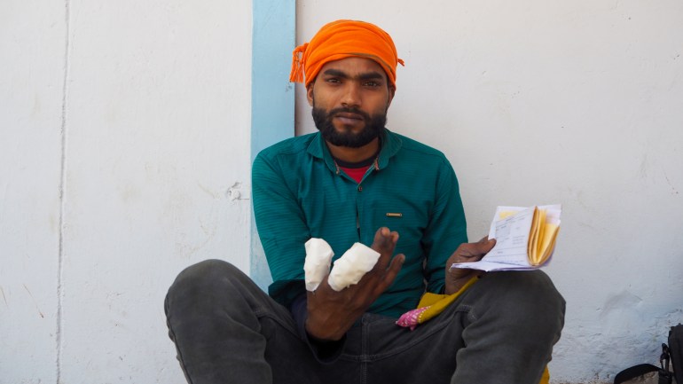 Manish Kumar,20 waits outside a government dispensary in Manesar Haryana, India