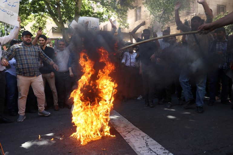 Demonstrators burn the Swedish flag 