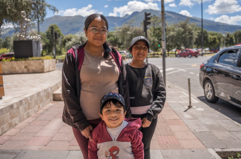 Diana Coyentes, 29, cleaning woman from the province of Cotopaxi is pictured with two children