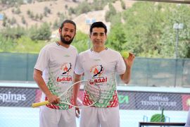 Footballer Mehdi Hobeh Darvish, right, with Amir Hossein Badi, one of Iran’s top tennis players, on an open-air tennis hardcourt located at the Espinas Palace Hotel