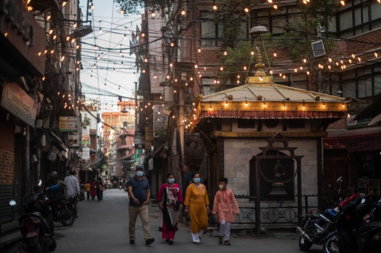 A photo of people walking through the Thamel tourist district.