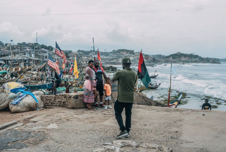 Tourists pose for pictures at the Cape Coast Castle on August 18, 2019 as it marked the "Year of Return" to remember the 400th anniversary of the first slave ship landing in Virginia