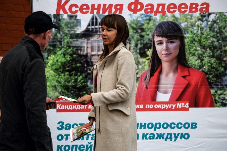 Ksenia Fadeyeva, 28, the head of Alexei Navalny's Tomsk headquarters and the city council candidate in September 13 regional elections, distributes campaign leaflets in the Siberian city of Tomsk on September 7, 2020.