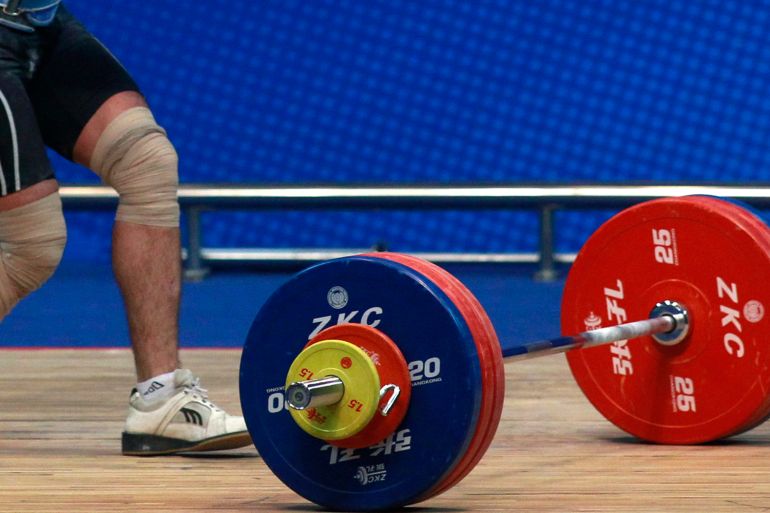 Iran's Morteza Rezaeian competes in the men's -69kg weightlifting competition at the 16th Asian Games in Guangzhou