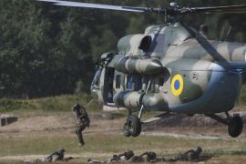 Members of the National Guard of Ukraine jump out a MI-8 helicopter during military tactical exercises at a training base near Kiev, Ukraine, July 22, 2015. REUTERS/Valentyn Ogirenko
