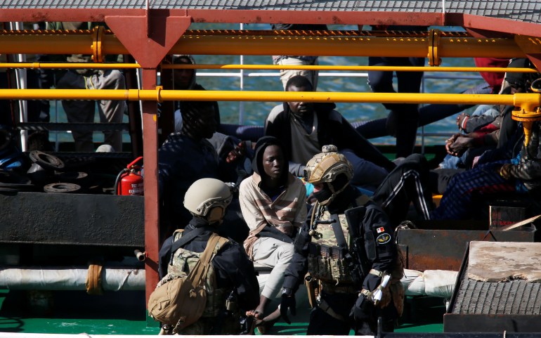 Maltese special forces soldiers guard a group of migrants on the merchant ship Elhiblu 1 after it arrived in Senglea, in Valletta's Grand Harbour, Malta, March 28, 2019. REUTERS/Darrin Zammit Lupi