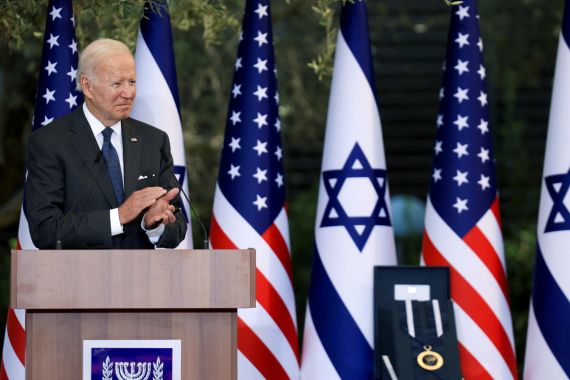US President Joe Biden speaks at a podium in Jerusalem in front of US and Israeli flags