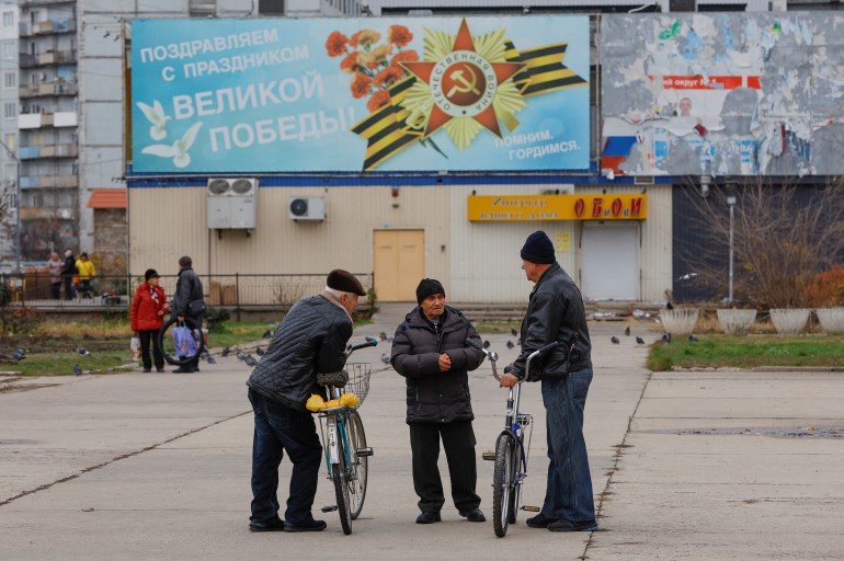Local residents speak in a street in the course of Russia-Ukraine conflict in the city of Enerhodar in the Zaporizhzhia region, Russian-controlled Ukraine, November 24, 2022. REUTERS/Alexander Ermochenko