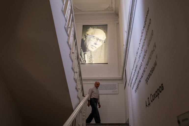 A man walks under a portrait of Nobel laureate and Soviet-era dissident Andrei Sakharov at the Sakharov Centre in Moscow