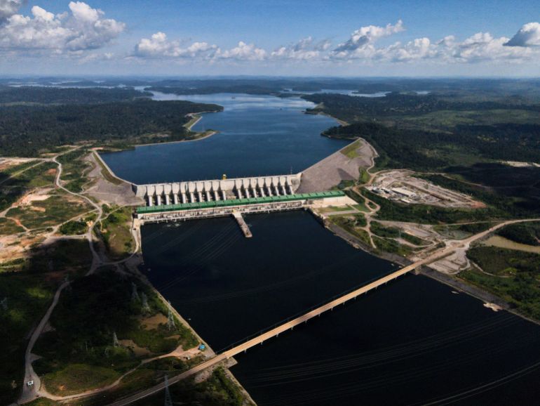 An aerial view of the Belo Monte dam spanning a river in the Brazilian Amazon.