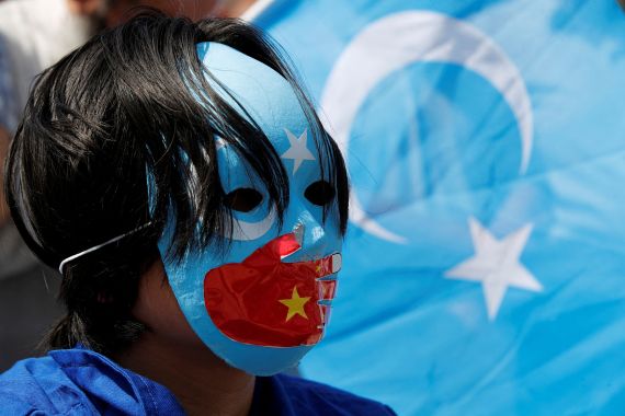 A Uighur demonstrator takes part in a protest