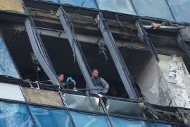 Members of security services investigate a damaged office building in the Moscow City following a reported Ukrainian drone attack in Moscow Russia, August 1, 2023.