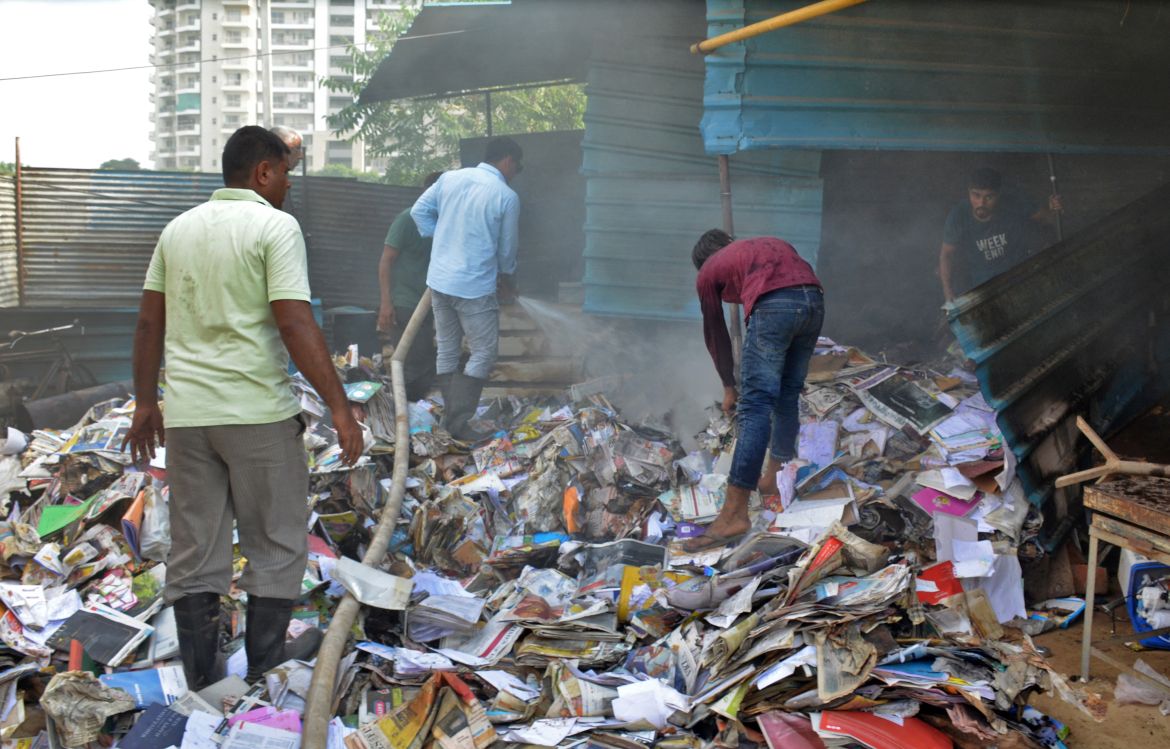 People search through the rubble of a scrap shop