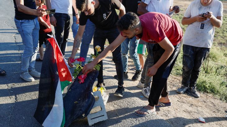 Palestinians gather at the scene where Israeli forces targeted a Palestinian car, near Jenin,
