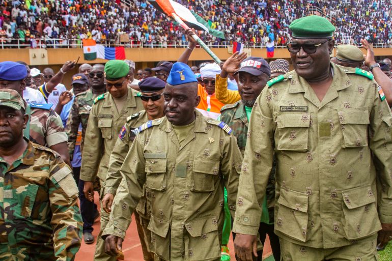 Members of a military council that staged a coup in Niger attend a rally at a stadium in Niamey, Niger, August 6, 2023.