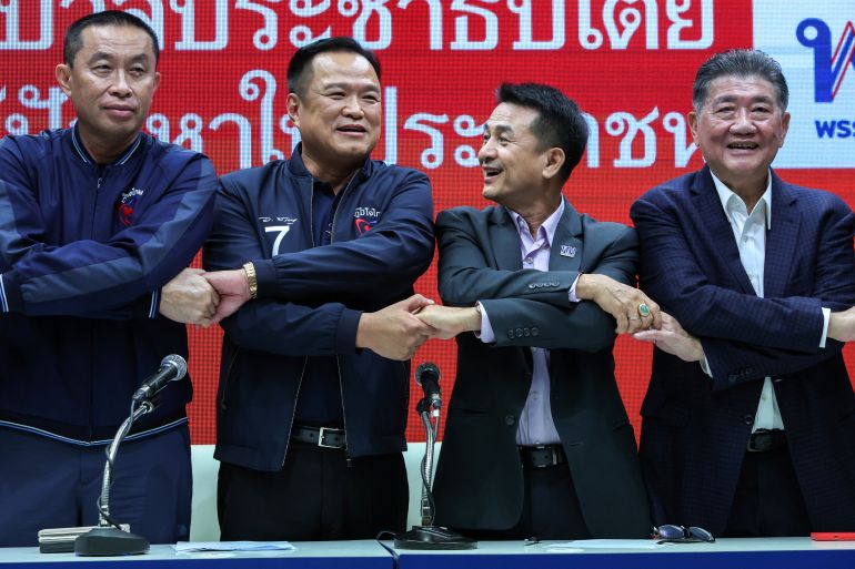 Bhumjaithai Party leader Anutin Charnvirakul and Pheu Thai Party leader Chonlanan Srikaew shake hands after a press conference