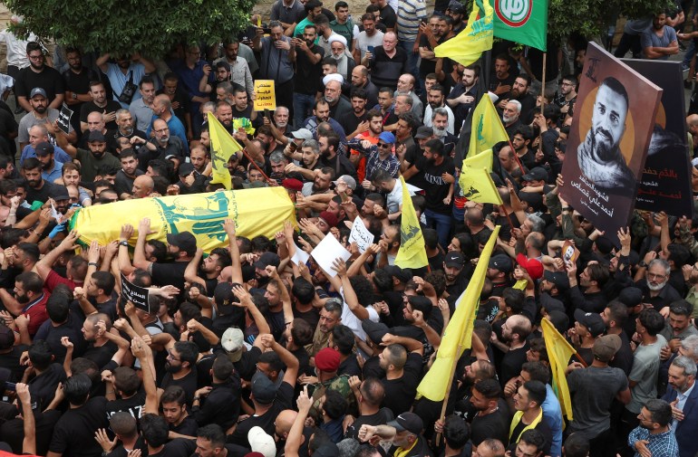 Supporters of Lebanon's Hezbollah carry the coffin of Ahmed Qassas, who died during exchange of fire at the area where a truck was overturned the previous night in the town of Kahaleh, during his funeral, in Beirut suburbs, Lebanon