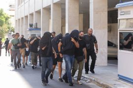 Soccer fans detained following violent clashes between AEK Athens and Dinamo Zagreb soccer fans, that lead to the death of a man, are taken to a magistrate, in Athens, Greece, August 11, 2023. REUTERS/Louiza Vradi