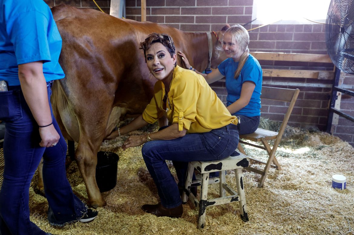 Kari Lake, former Republican candidate for Governor of Arizona, milks a cow in the cattle barn at the Iowa State Fair in Des Moines, Iowa, U.S., August 11, 2023.