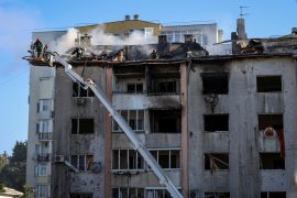 Rescuers work at a site of a residential building destroyed during a Russian military strike in Lviv, Ukraine