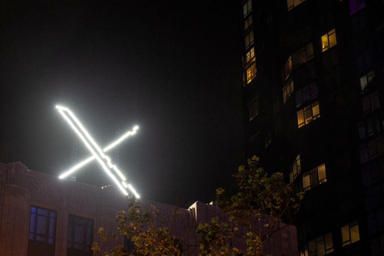Lit up "X" symbol on top of a building