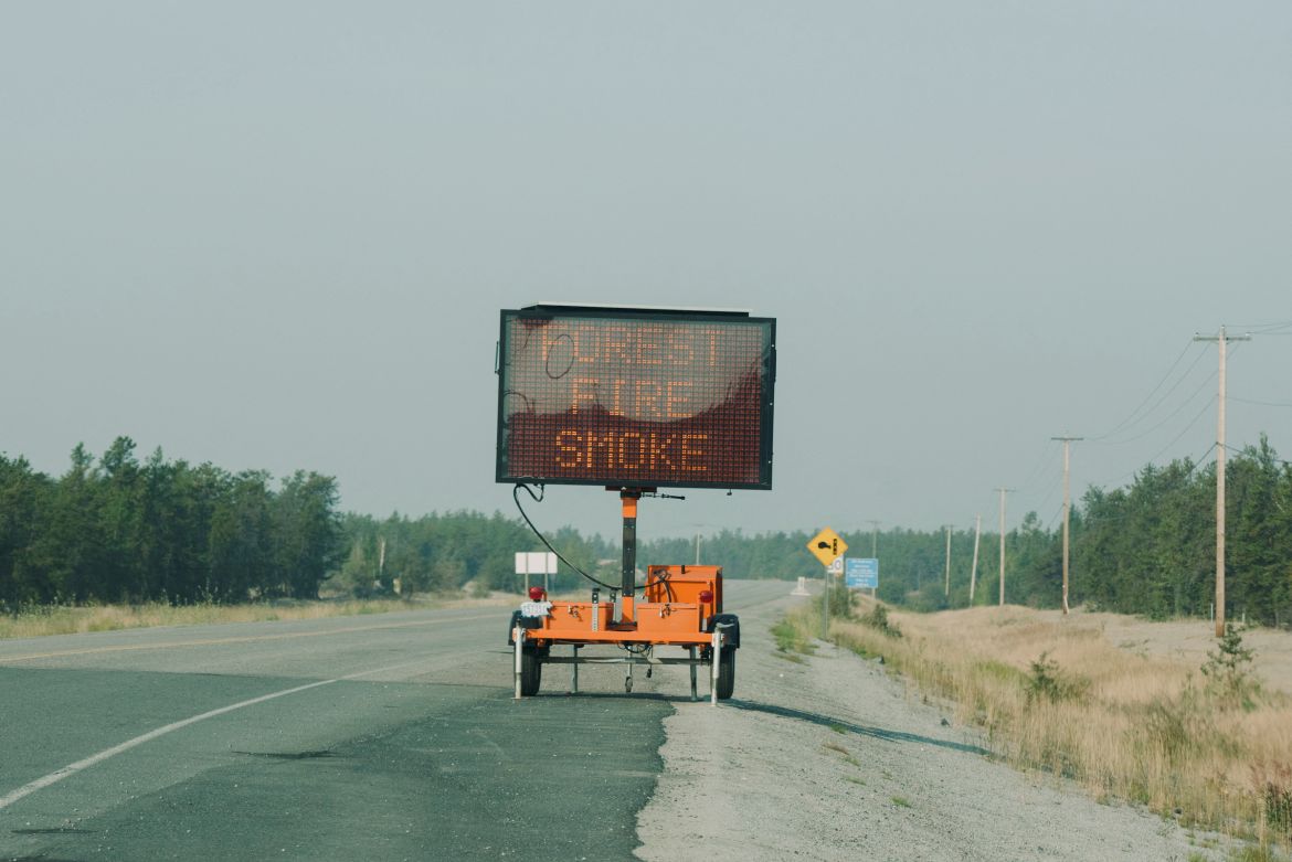A road sign provides updates on traffic conditions on the only highway in or out of Yellowknife after a state of emergency was declared due to the proximity of a wildfire in Yellowknife