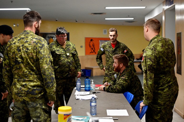 Members of the First Canadian Ranger Patrol group based out of Yellowknife, debrief at a local school