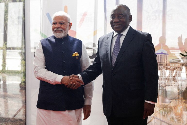 Prime Minister of India Narendra Modi shakes hands with South African President Cyril Ramaphosa during the 2023 BRICS Summit