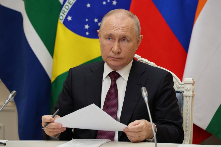 Russian President Vladimir Putin takes part in a press conference during the 15th BRICS Summit, via video link