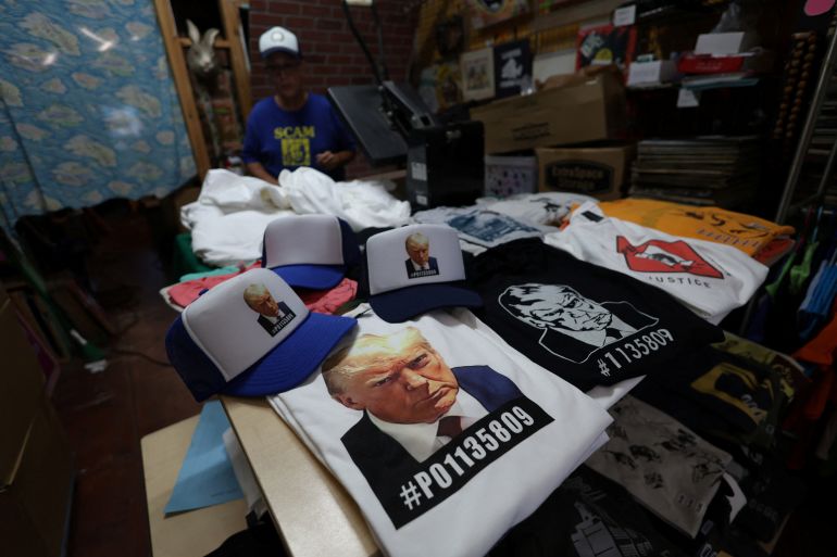 T-shirts and hats with an image depicting the mugshot of former U.S. President Donald Trump are pictured after being printed at the Y-Que printing store in Los Angeles, California, U.S., August 26, 2023.