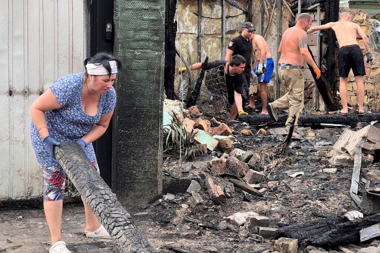 Residents clearing debris after the Russian missile and drone attack around Kyiv.