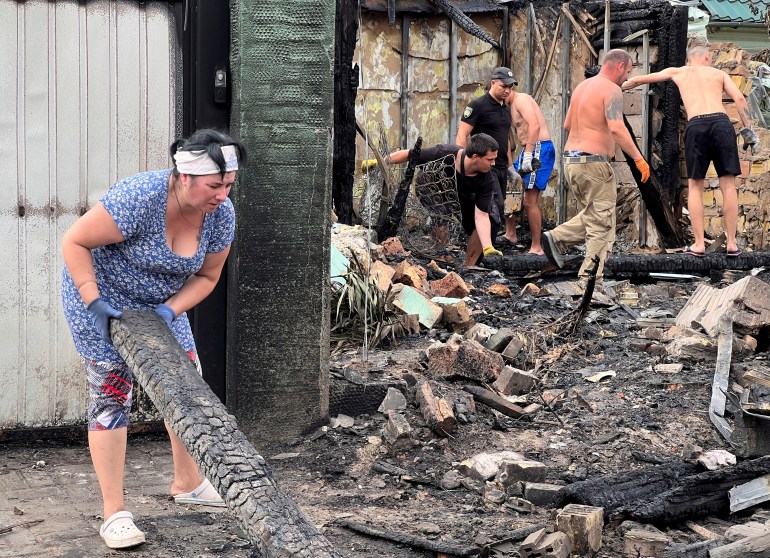 Residents clearing debris after the Russian missile and drone attack around Kyiv.