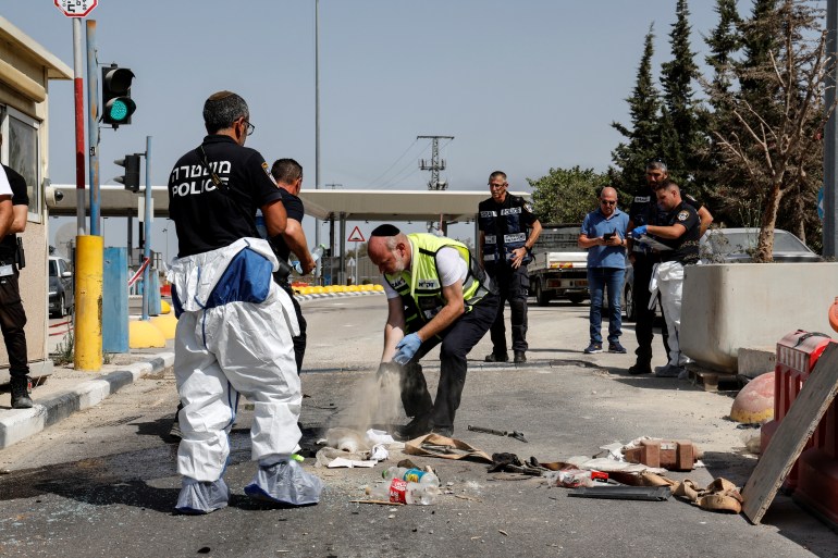 Israeli security and rescue forces work at a checkpoint after a Palestinian car ramming attack