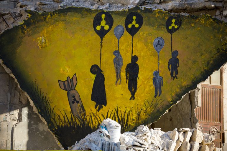 A mural showing the shadows of lifeless bodies hung by a chemical balloon