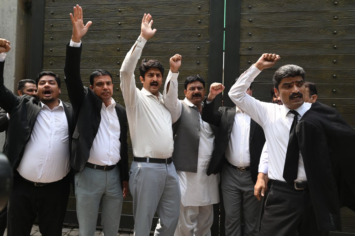 Lawyers and supporters of former Pakistan prime minister Imran Khan shout slogans against Khan's arrest outside his residence in Lahore on August 5, 2023. - Khan was found guilty of graft on August 5 and sentenced to three years in jail, state TV said, in a case involving gifts he received while premier