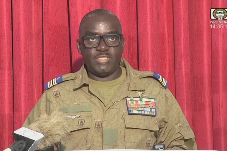 This video frame grab image obtained by AFP from ORTN - Télé Sahel on August 9, 2023 shows Colonel Major Amadou Abdramane, a CNSP (Conseil national pour la sauvegarde de la patrie) member, reading a statement on national television. - Niger's military leaders accused France of breaching a ban on the country's air space, a charge that came on the eve of a West African summit following a coup two weeks earlier.